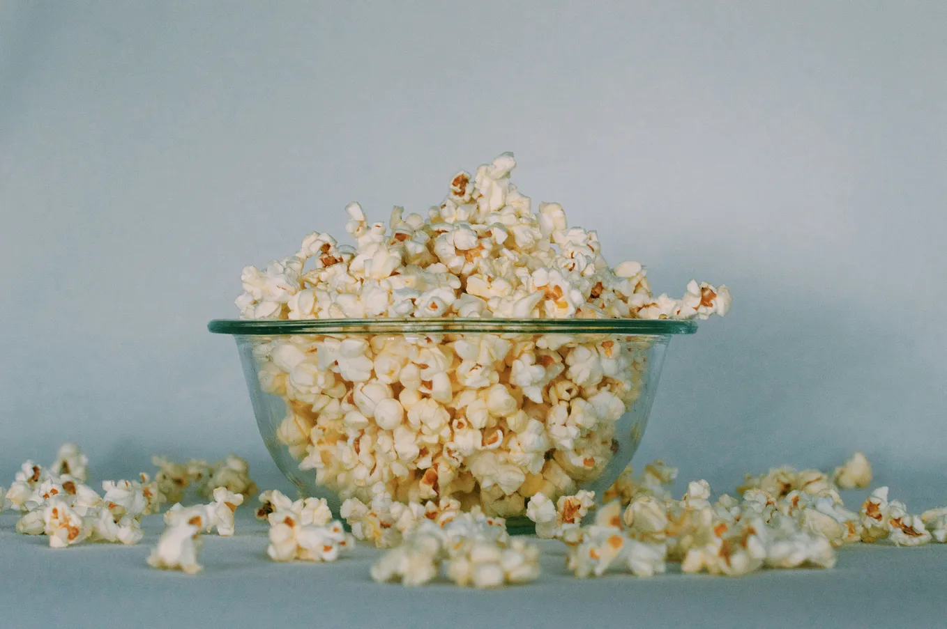 Overflowing bowl of freshly popped popcorn