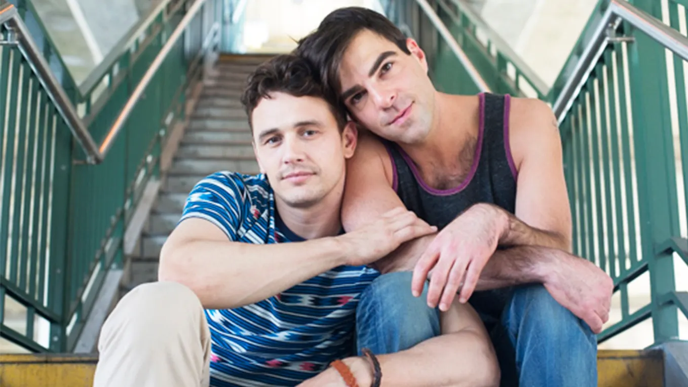 Two men sit closely together on a stairway, one resting his arm around the other, in a scene from I Am Michael.