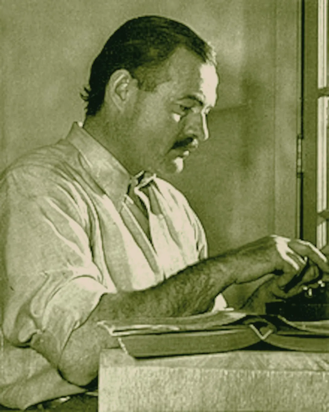Hemingway writing on typewriter