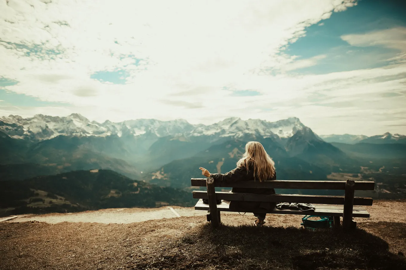 Woman on a bench looking out into a canyon