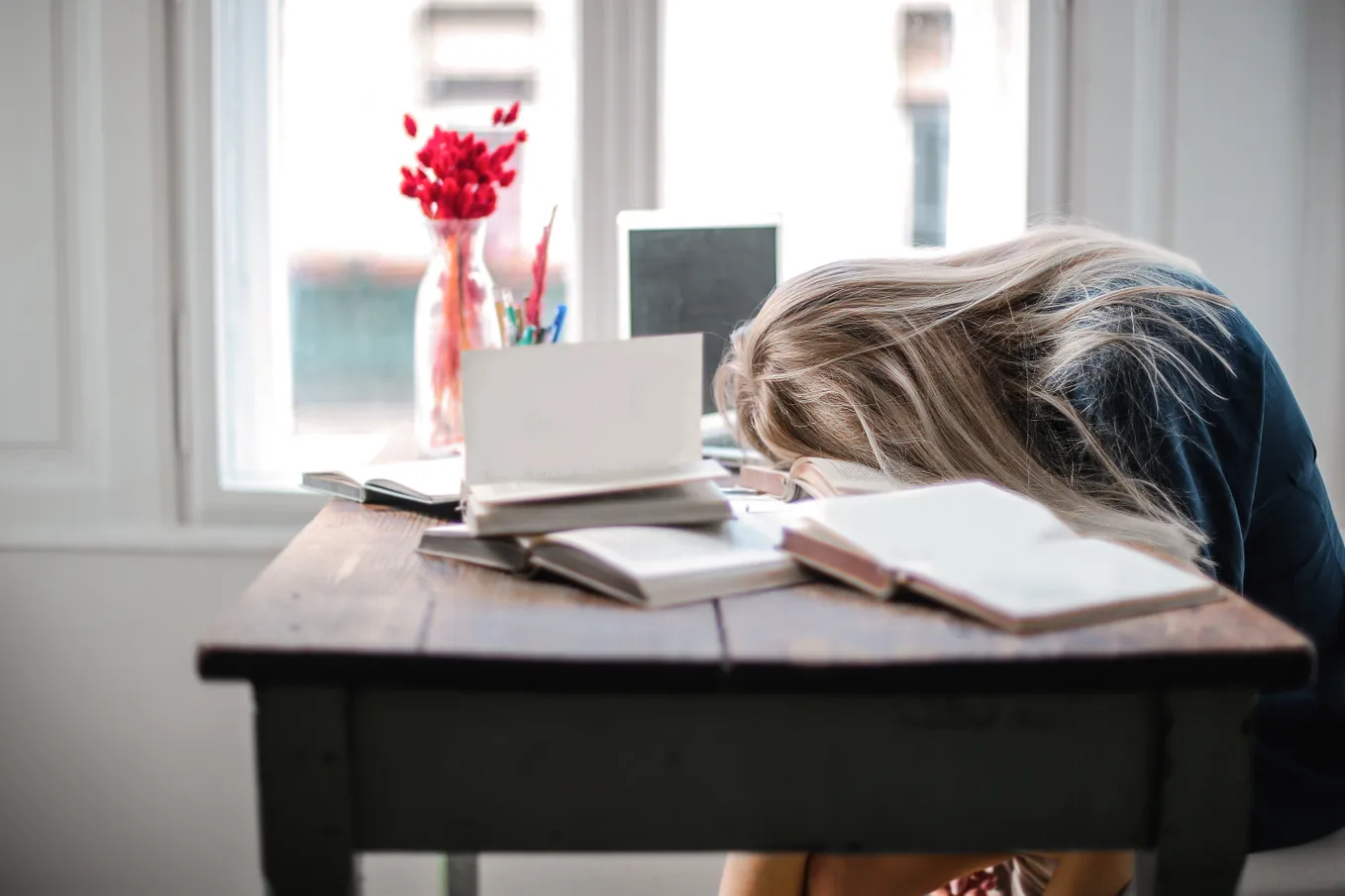 Woman with her head on her desk.