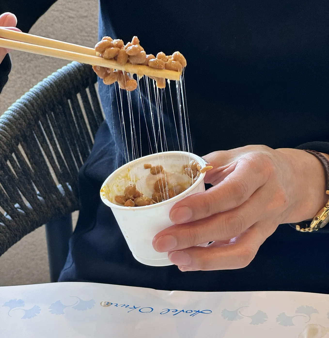 Natto being eaten from container using chopsticks