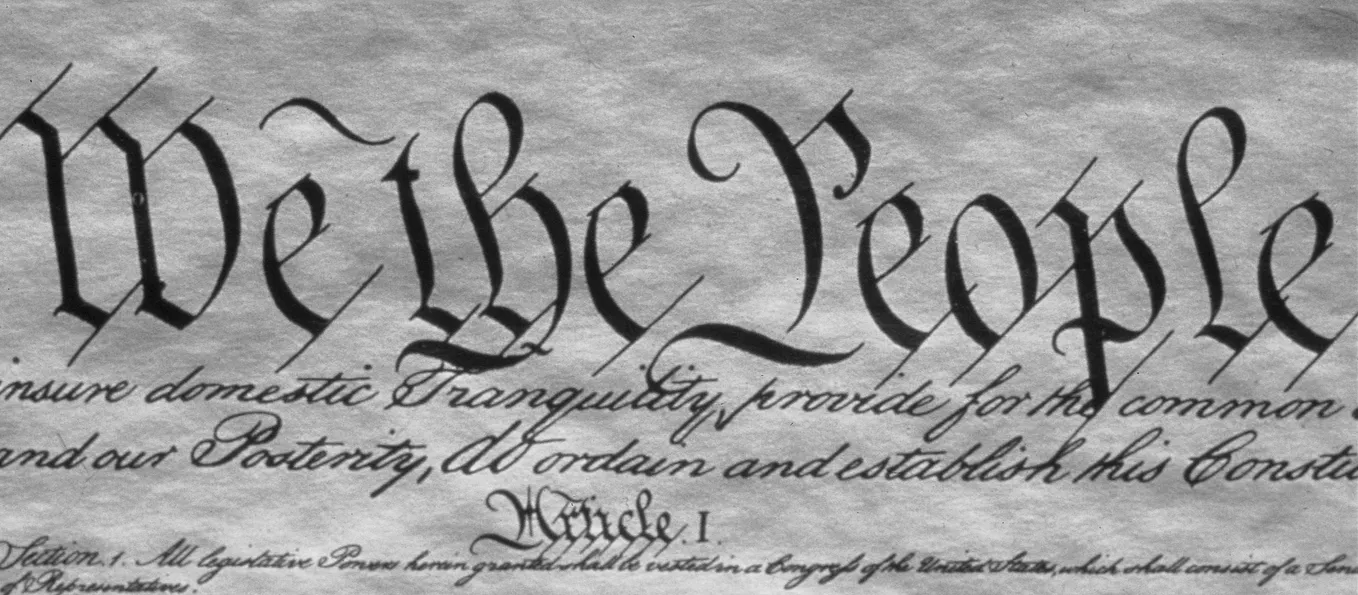 An image of the first few lines of the Constitution of the United States.