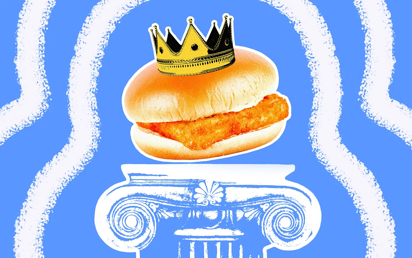 A photo illustration of a generic fish sandwich wearing a crown, placed on a pedestal.