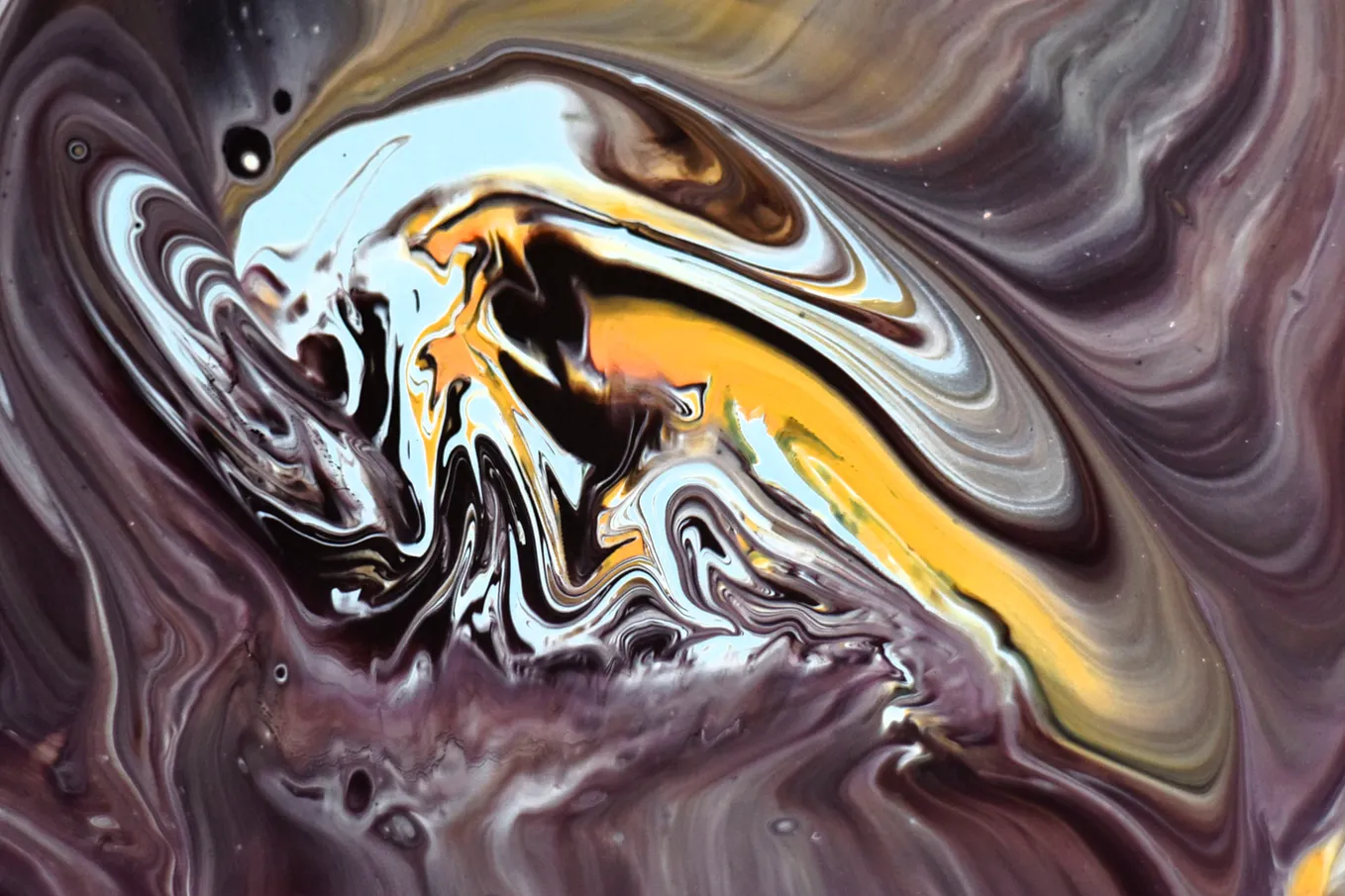 An abstract purple, white, black and yellow picture. To me it looks like a pained skull/skeleton in a cosmos.