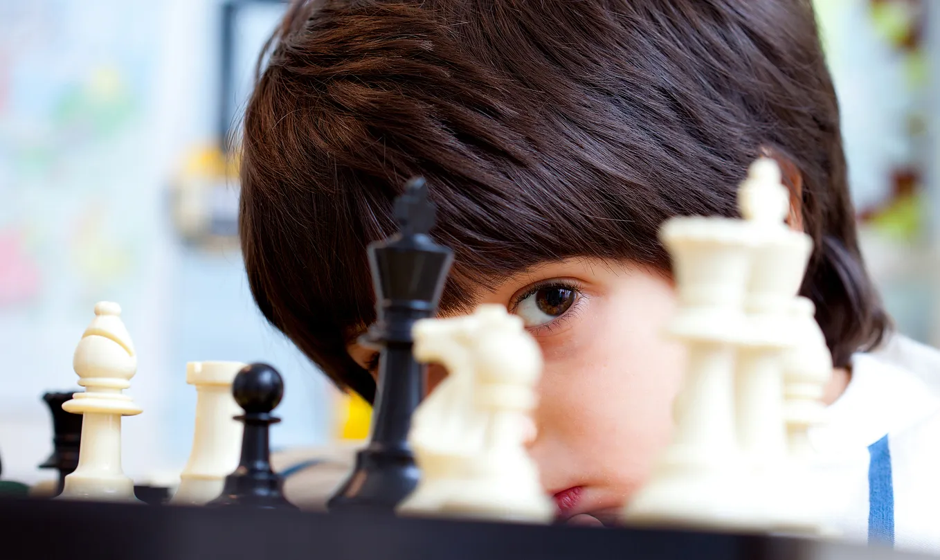 Young boy playing chess