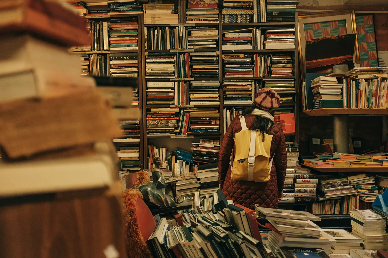 A person staring at unread books