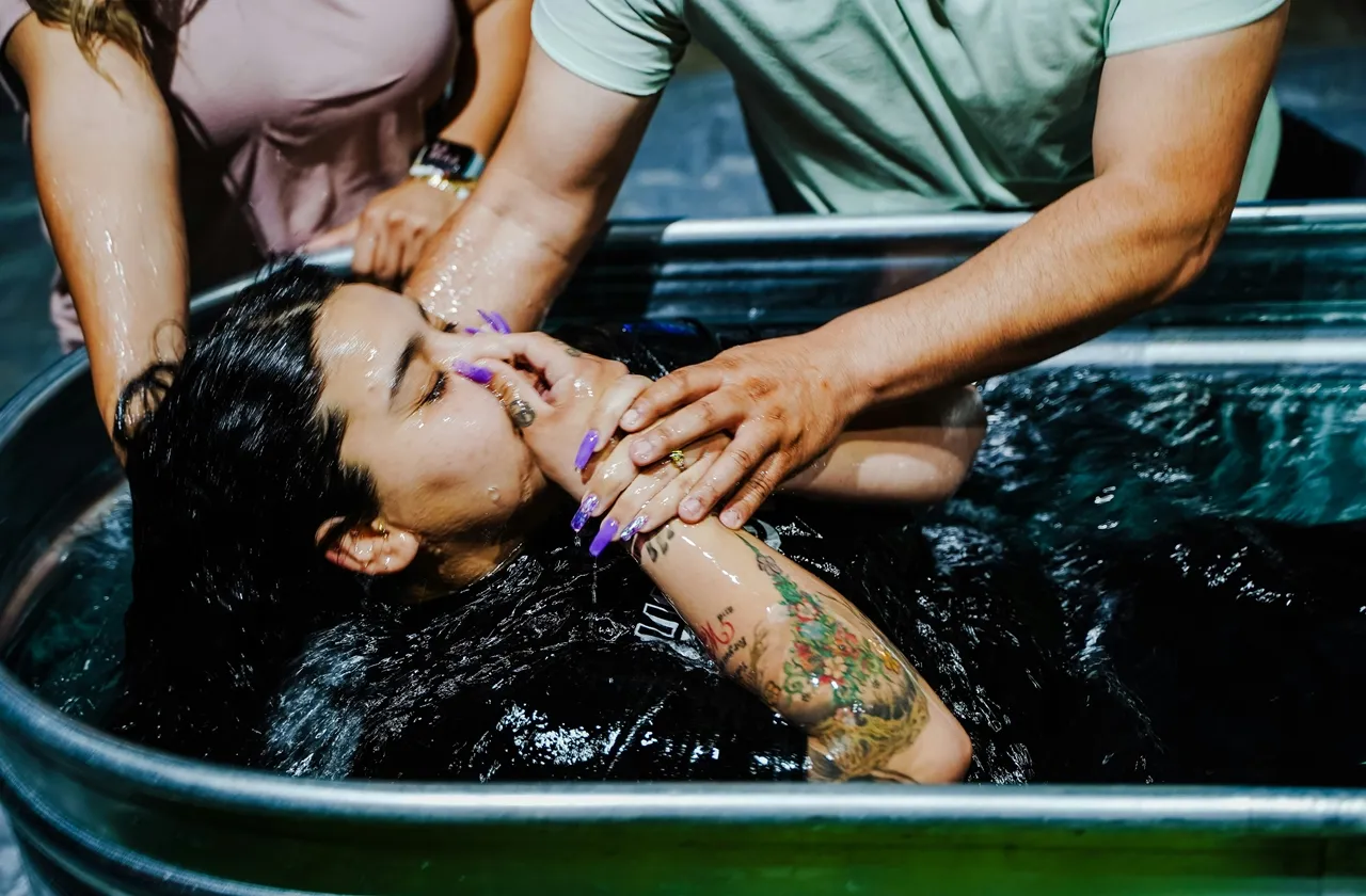 A young lady being baptized