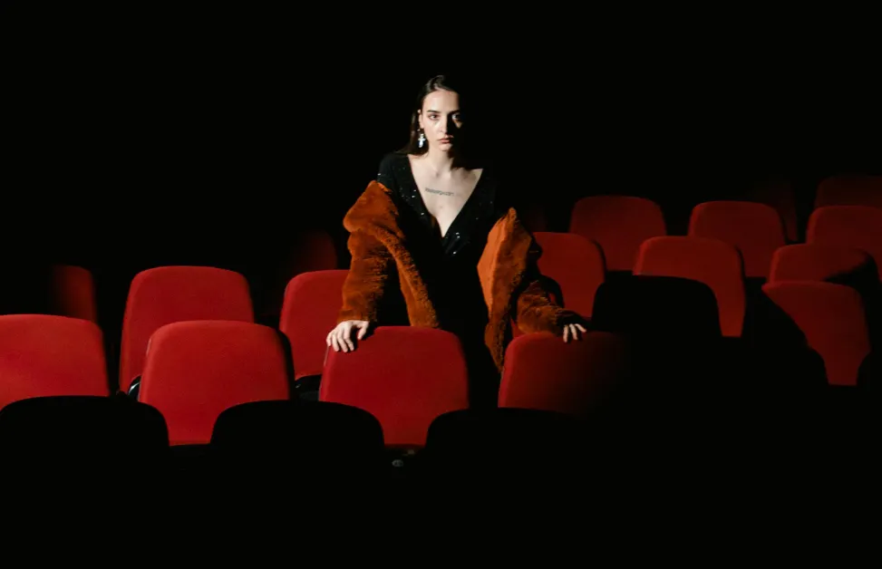 A girl in red in a room to demonstrate herself