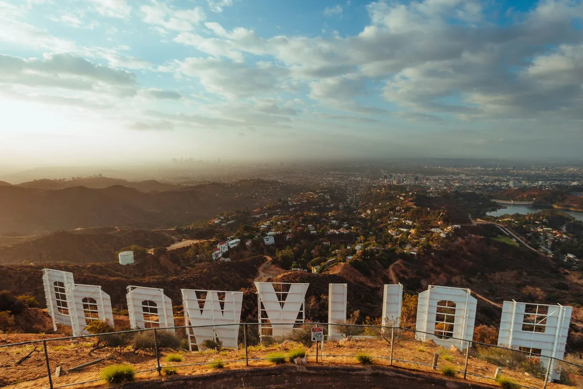 A view of Hollywood from above and behind the famous Hollywood sign, which can be seen in shot, reversed.