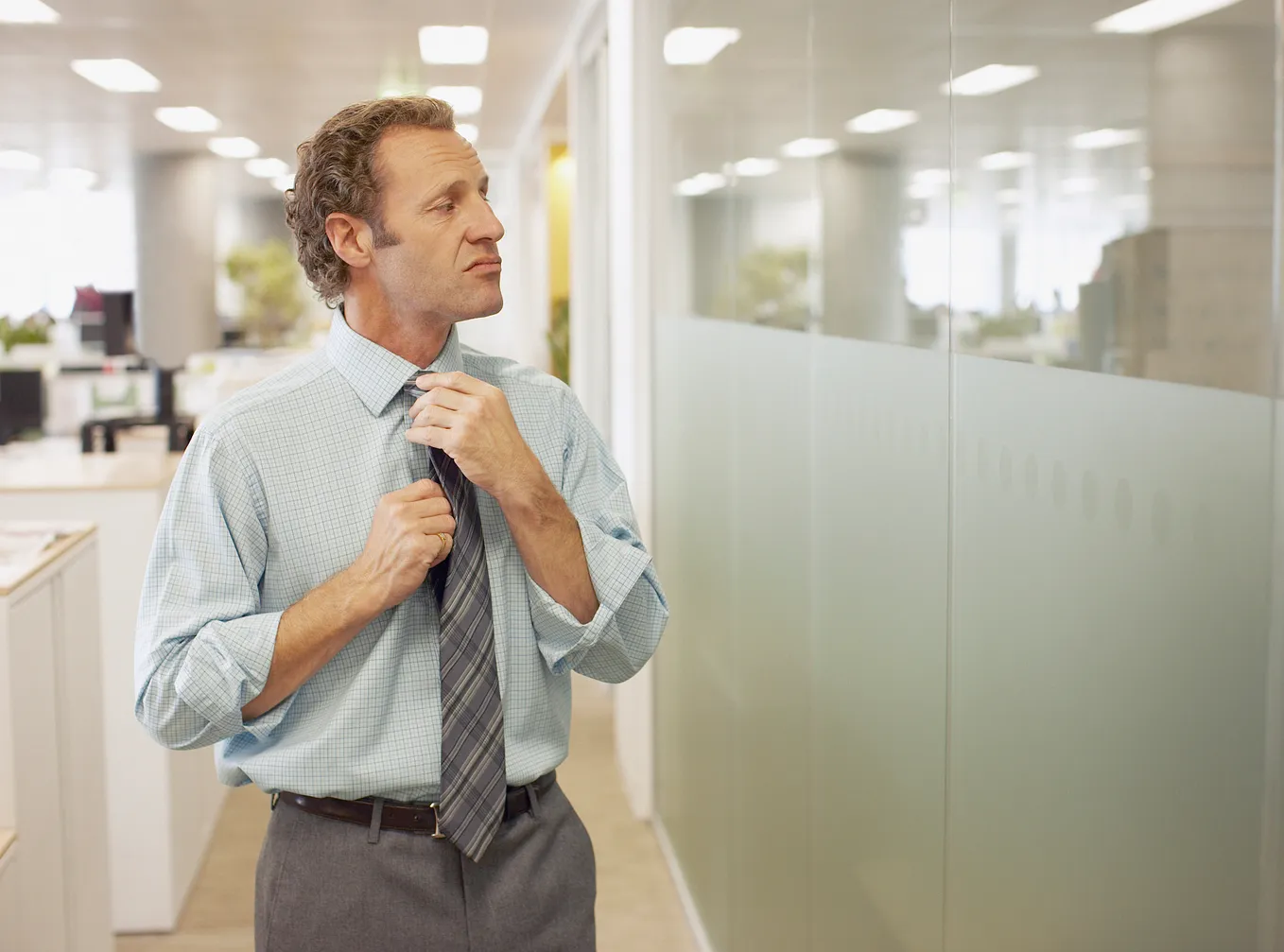 Man adjusting his tie.