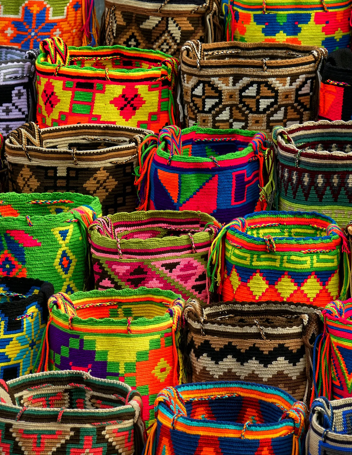 multiple colorful with distinct geometric patterns baskets lined up in rows