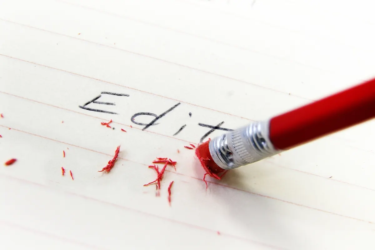 A pencil erasing the word edit