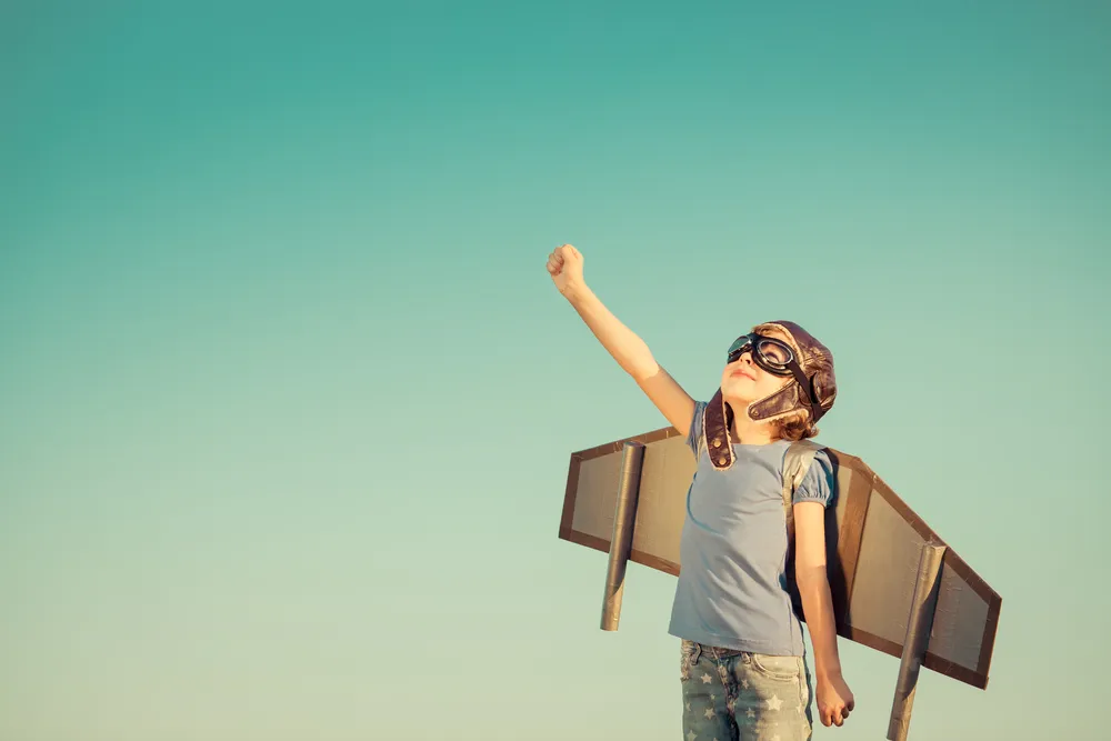 Picture of a boy with wings on his back, ready to set off