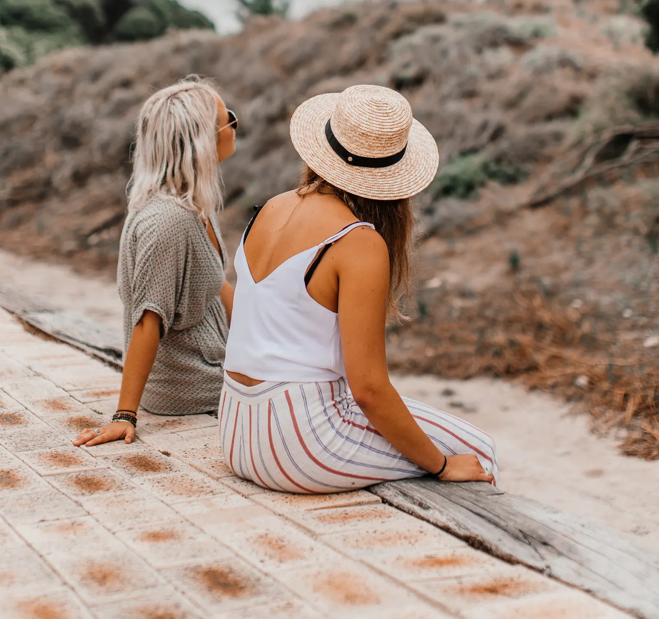 a blonde woman and a brunette sitting