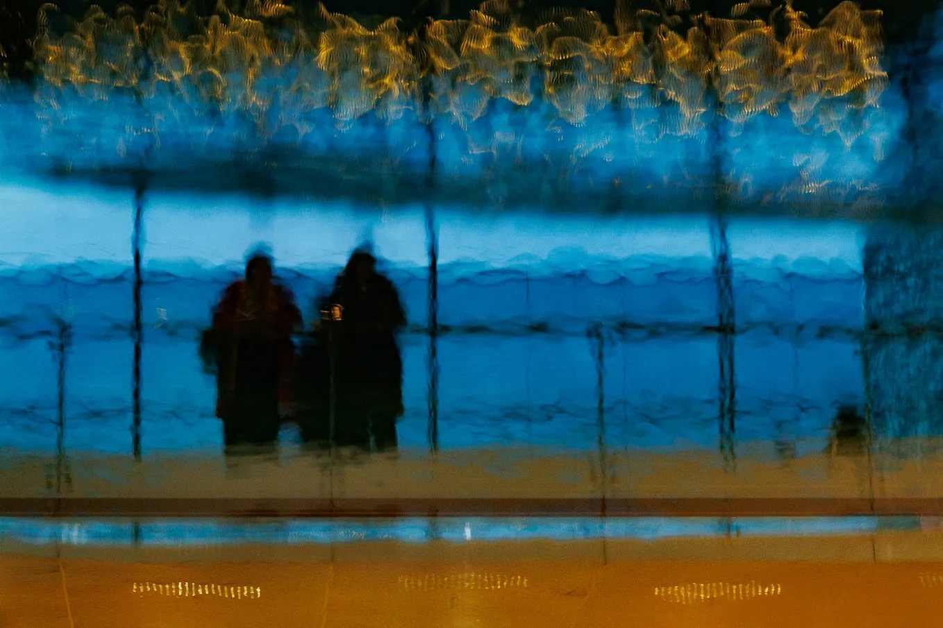 Two shadowy blurred figures in a corporate building representing an inability to see people’s true nature