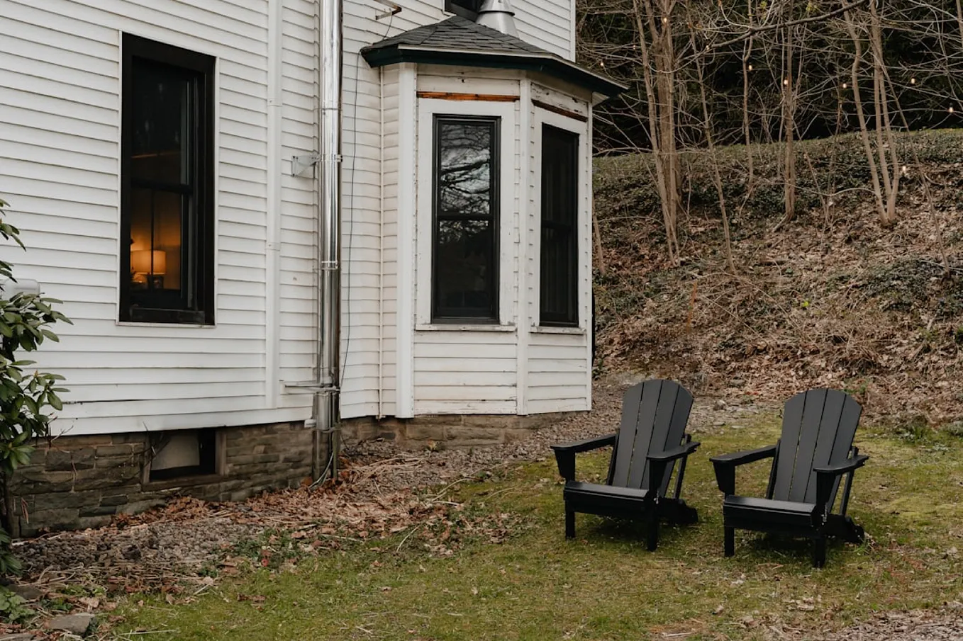 Two empty Adirondack chairs side by side.