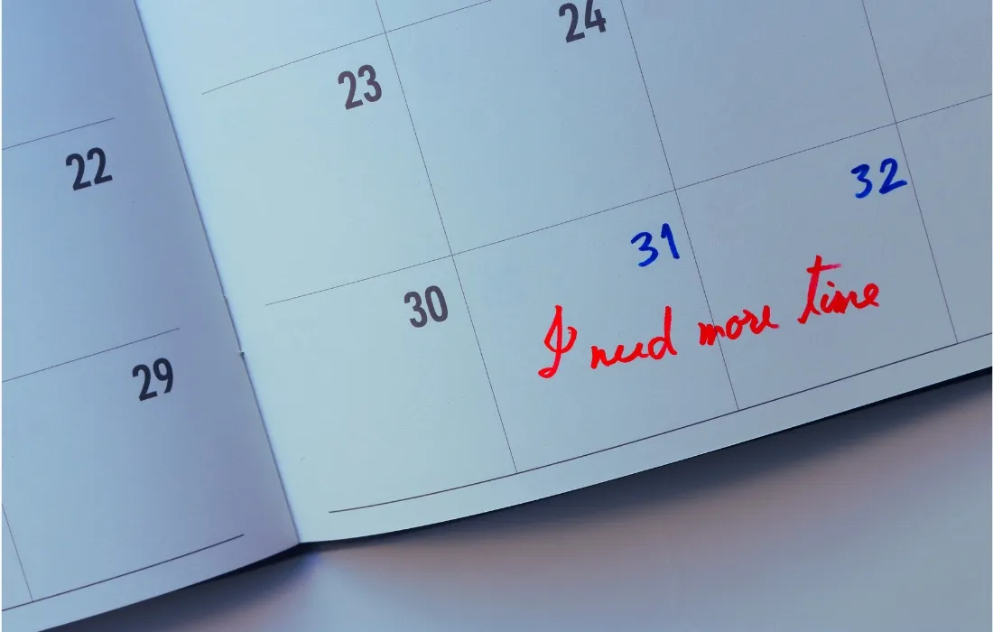An open planner with the words I need more time written on it
