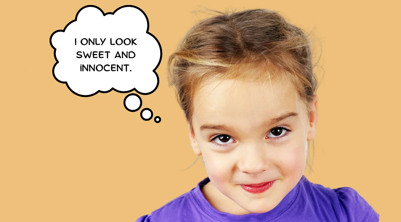 A young girl with a mischievous smile and a thought bubble that says “I only look sweet and innocent.”
