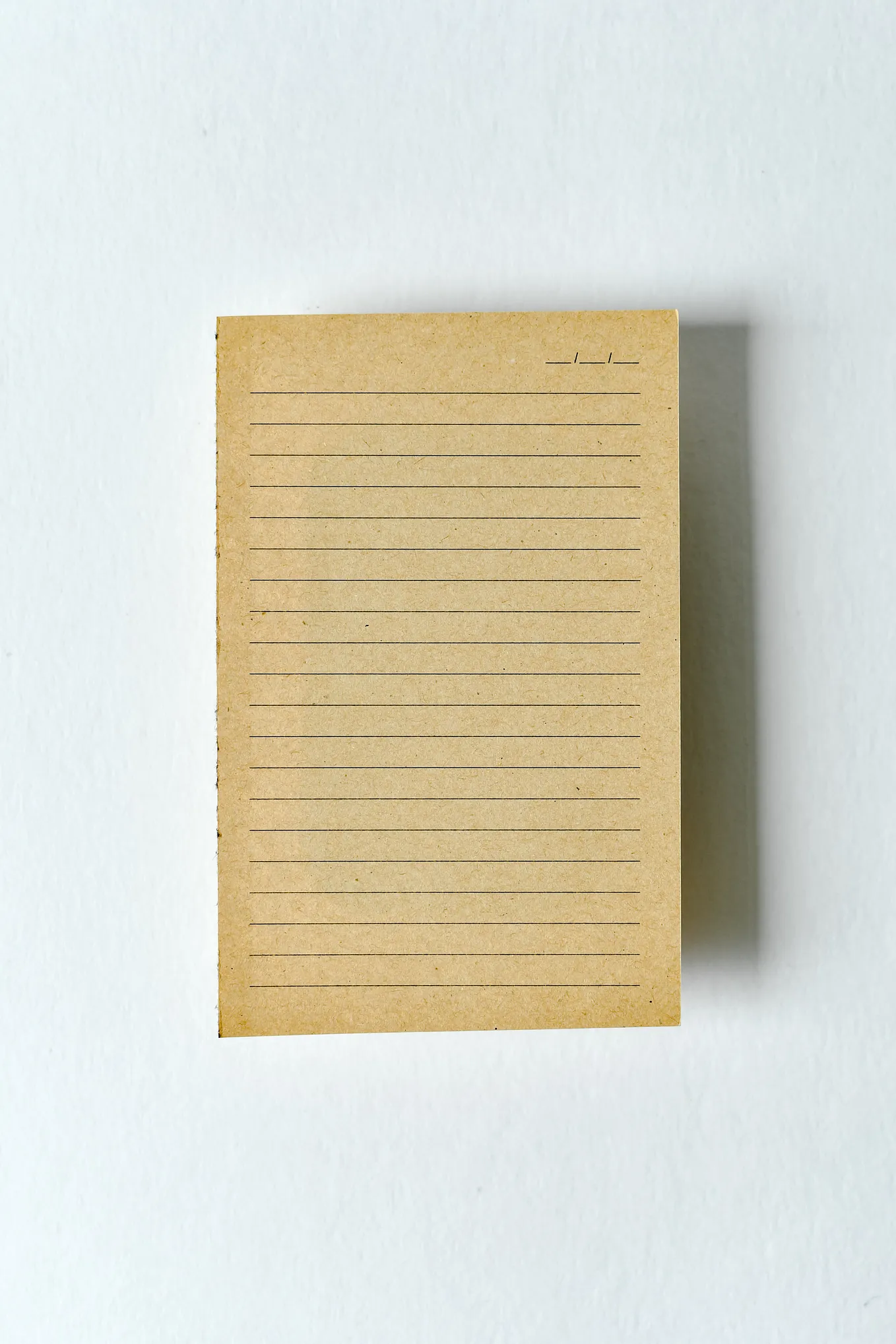 blank piece of tan line paper on white background