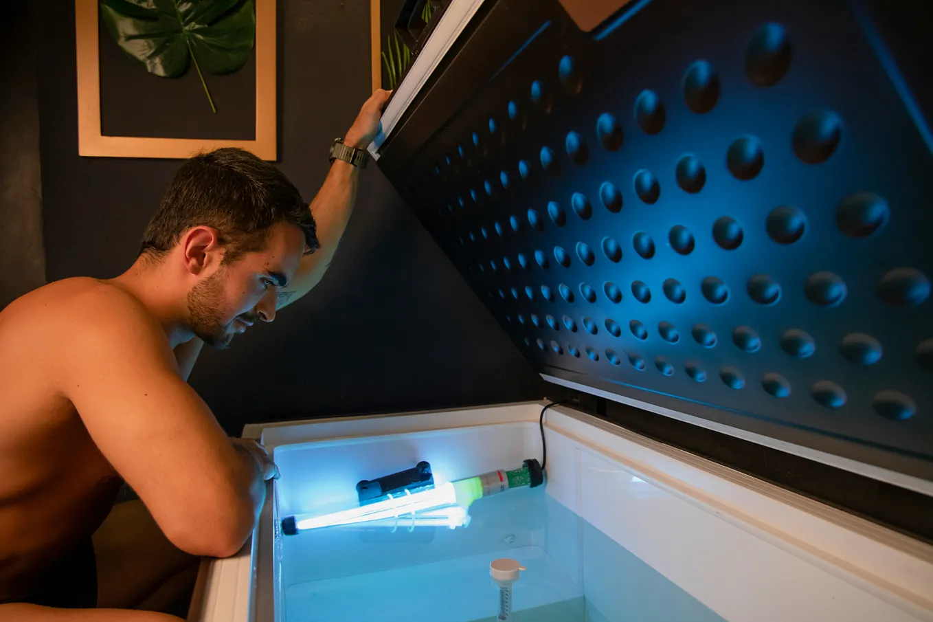 man setting up ice bath and checking the temperature gage