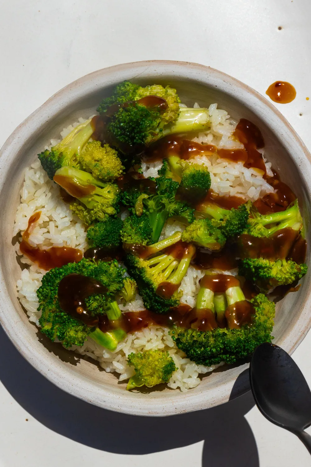 Stir fry sauce spread over rice and broccoli