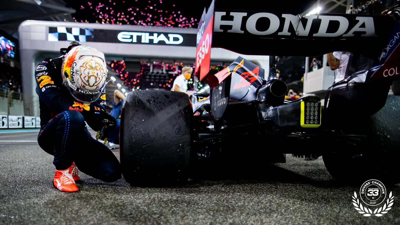 Max Verstappen takes a knee after winning the championship race in Abu Dhabi