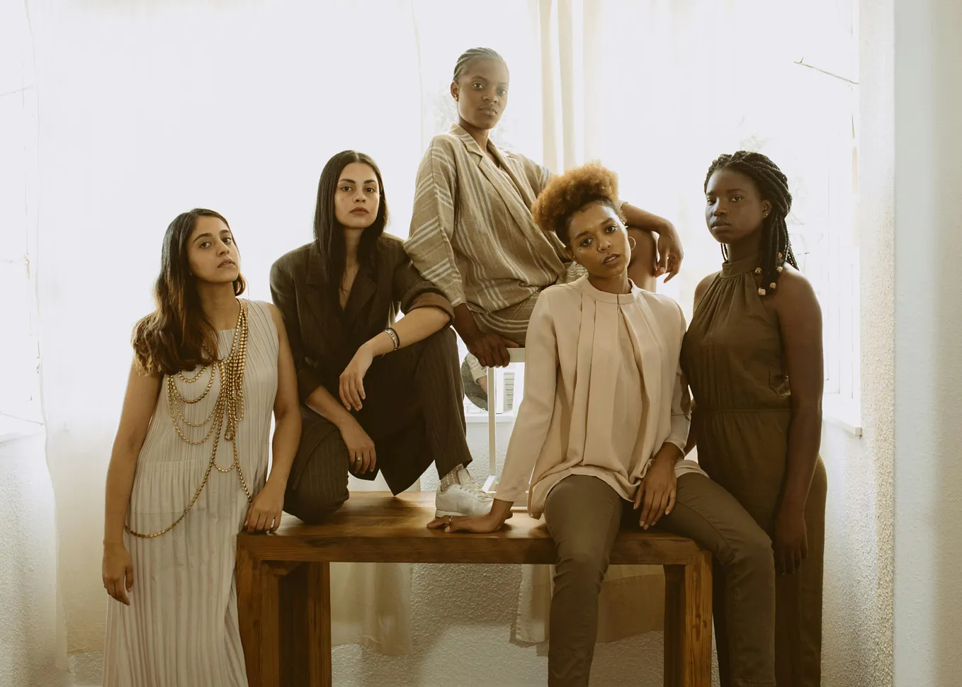 Five women of various ethnicities looking powerfully at the camera