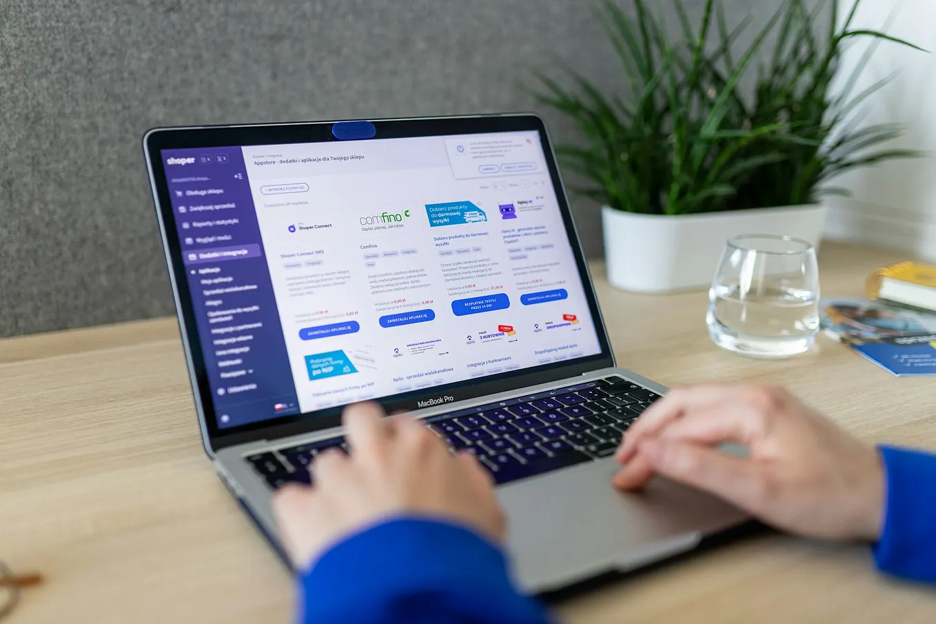 A small business owner using a laptop to manage an online store dashboard. Photo by Shoper on Unsplash