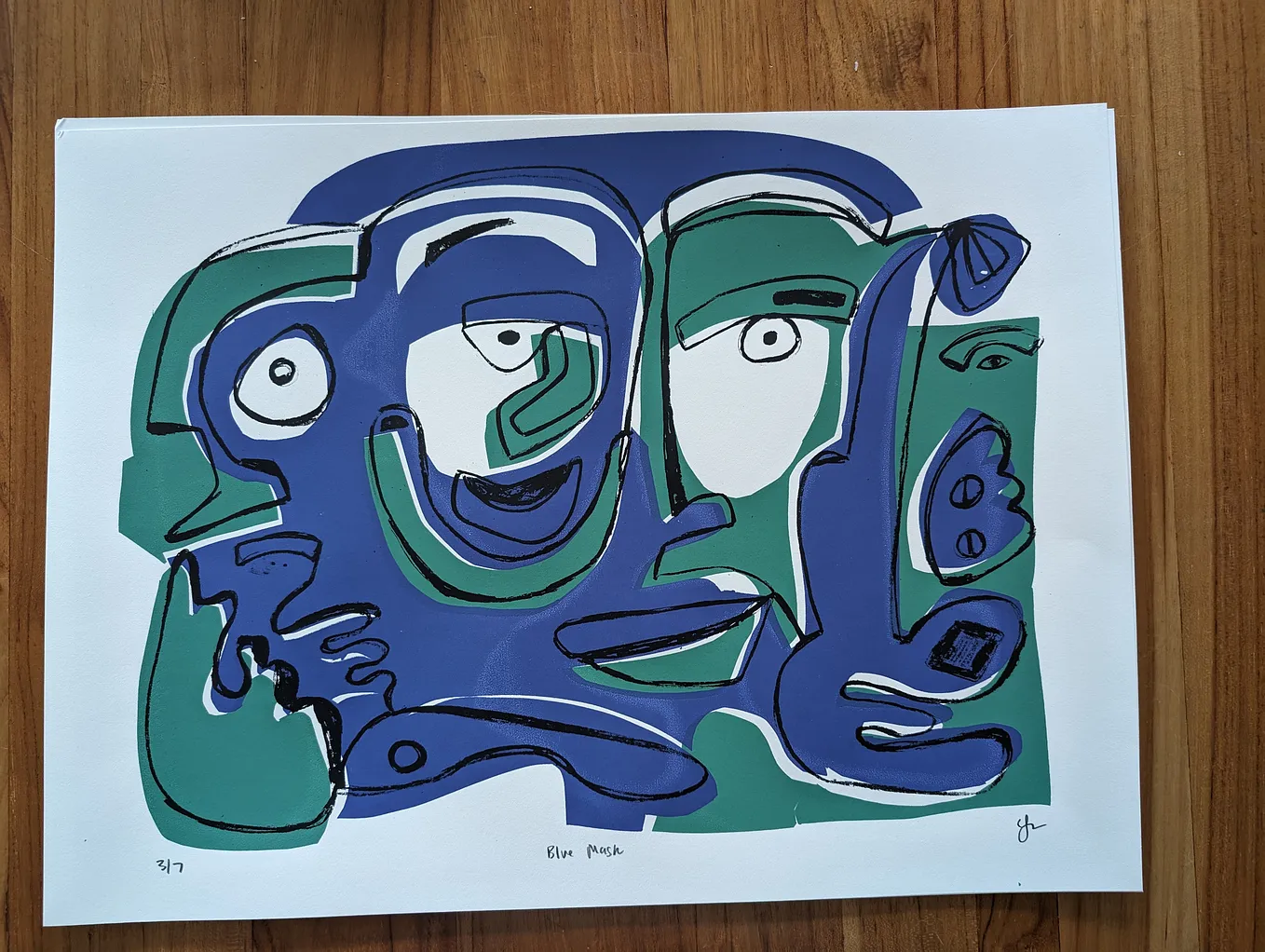 A blue and green silkscreen of a face in shapes