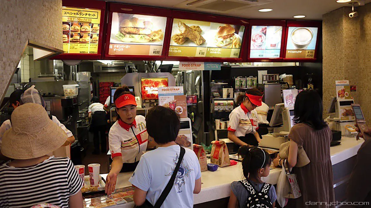 Fast food workers serving customers.