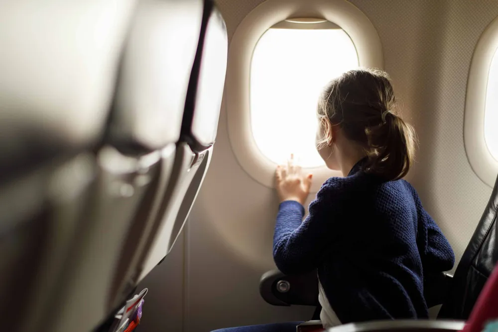 A Child in the Window of a Plane