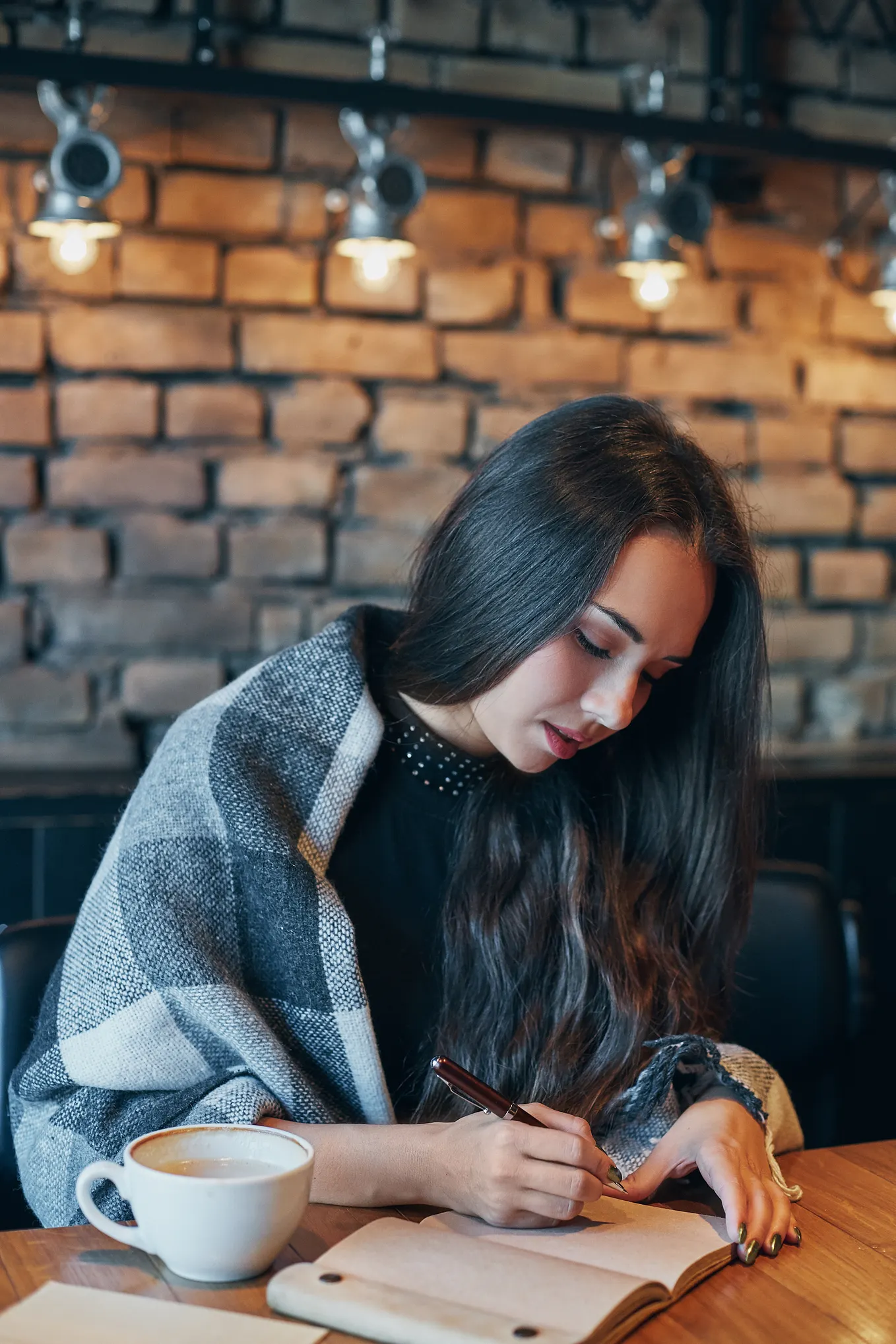 A woman drinking coffee in restaurant.