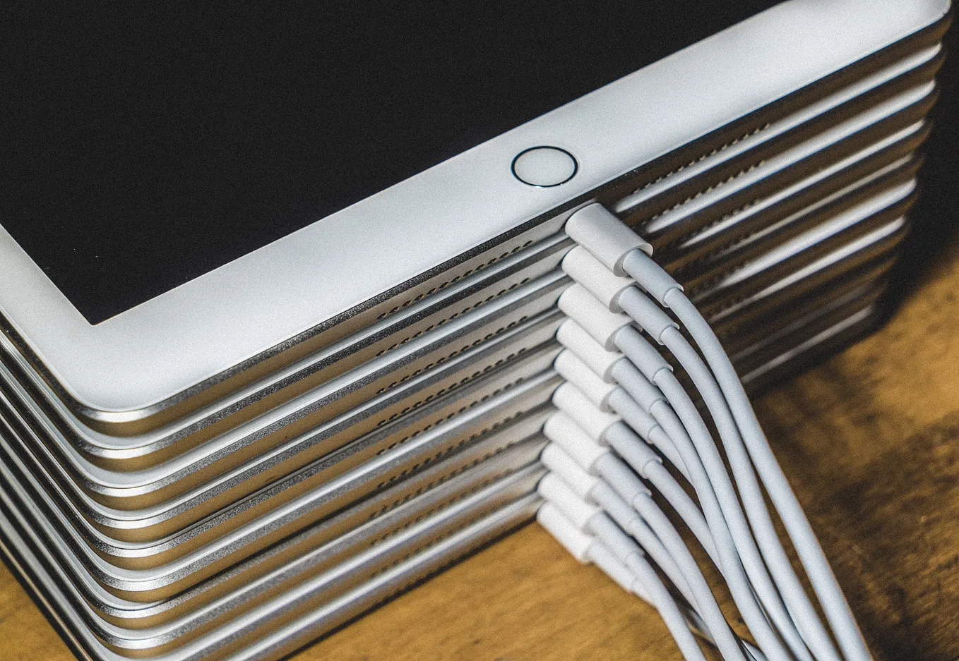 A stack of iPads charging