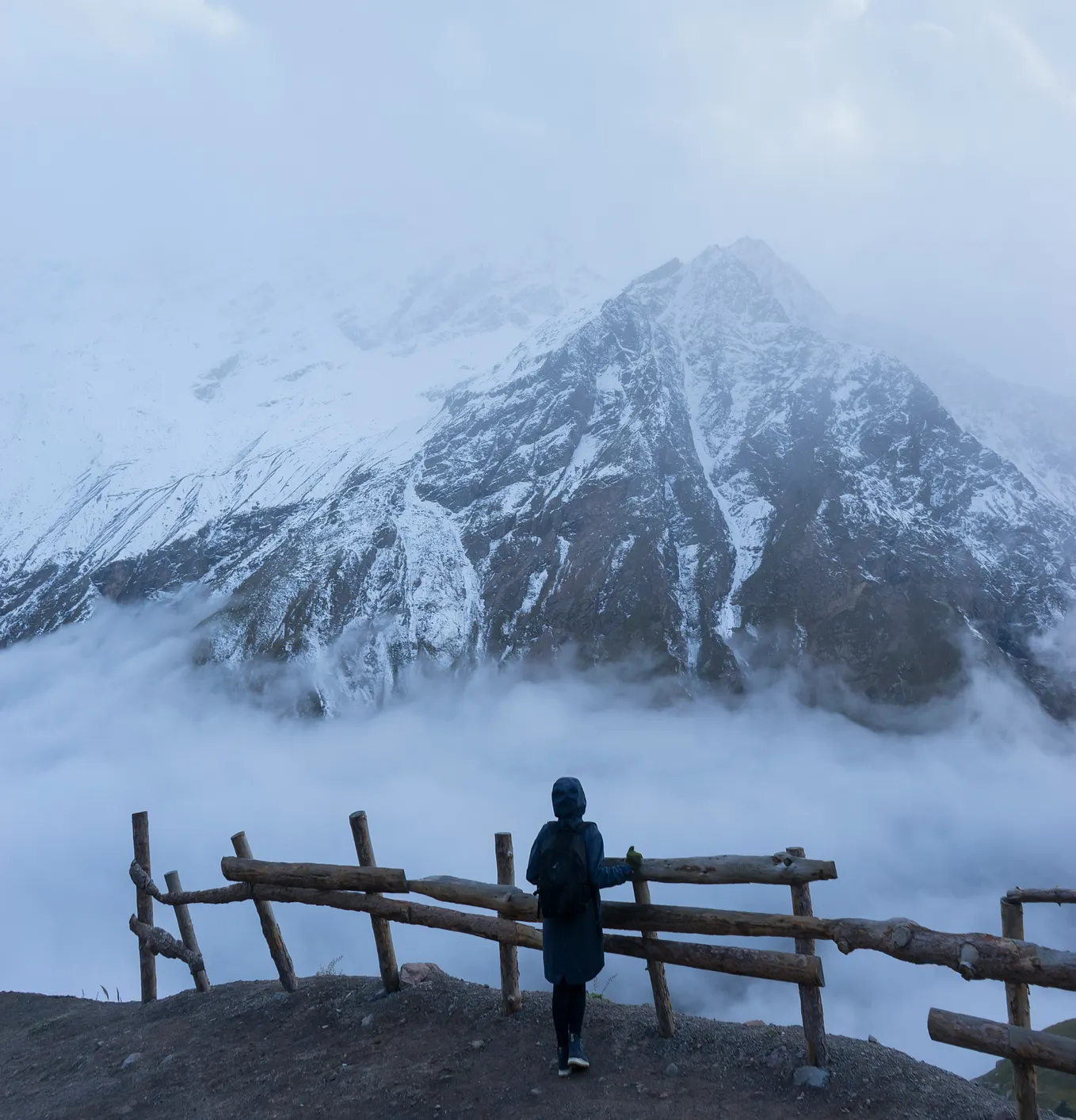a person standing at the top of a mountain