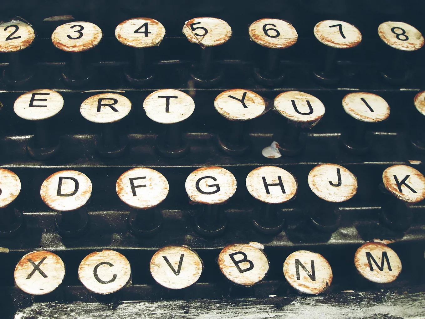 Closeup of middle keys on an old typewriter, slightly bent out of shape