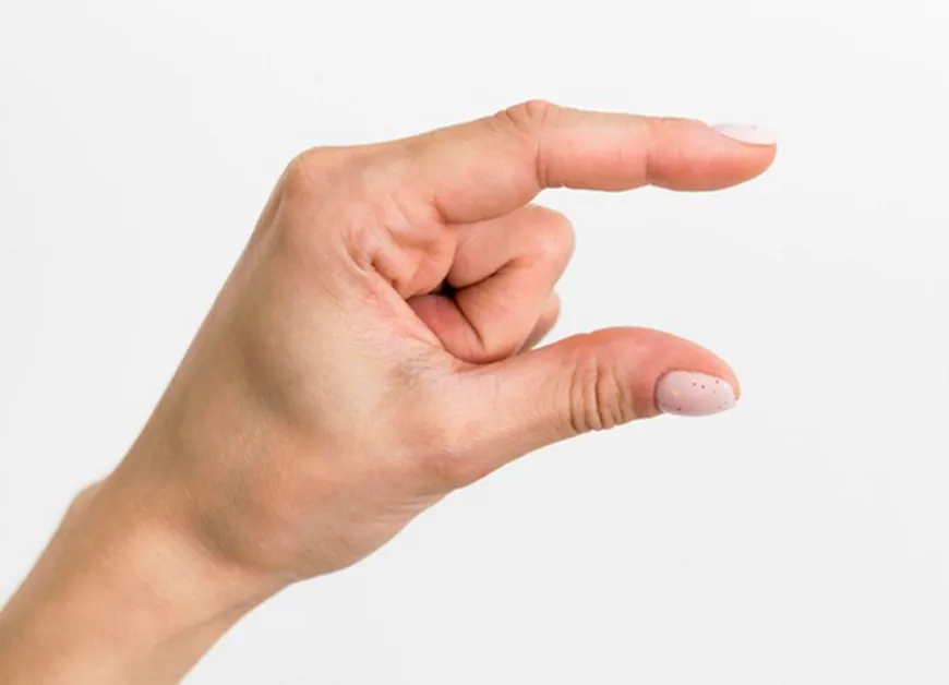 A photo of a person’s hand from the side, holding their thumb and index finger about one inch apart.