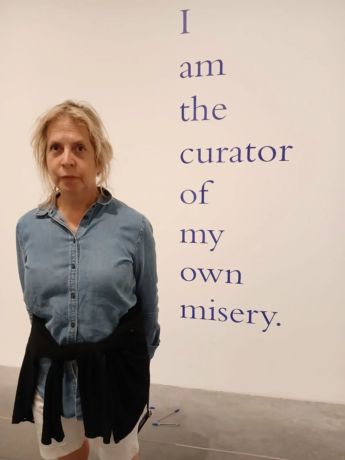 Picture of the author considering the statement, ‘I am the curator of my own misery,’ which was written on a wall of the Tate Modern Museum in London