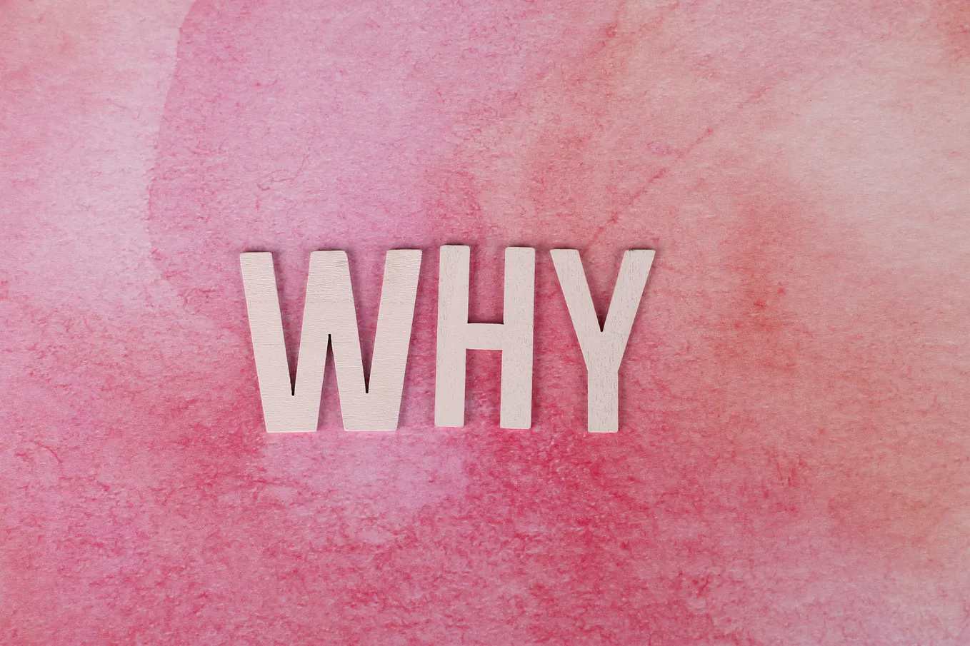 The word why against a pink-colored background