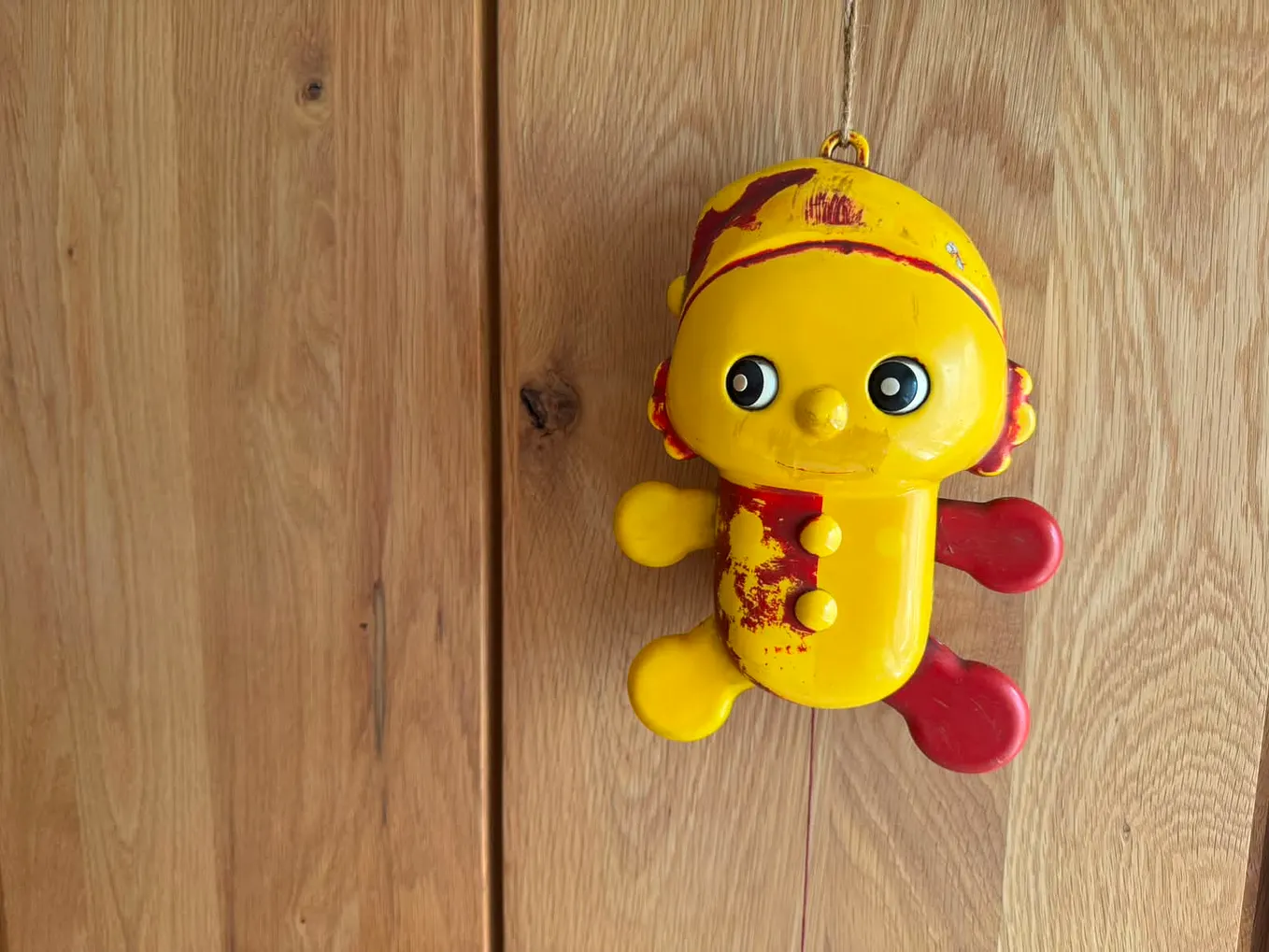 An image showing an old plastic pull-string music toy.