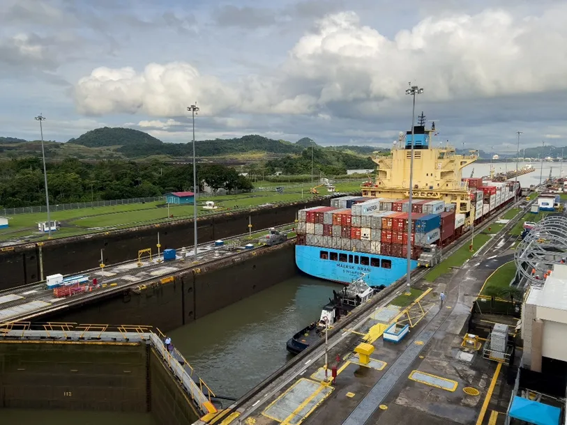 Container ship passing through the Miraflores Locks of the Panama Canal. The ship is traveling northbound from the Pacific Ocean to the Atlantic Ocean.