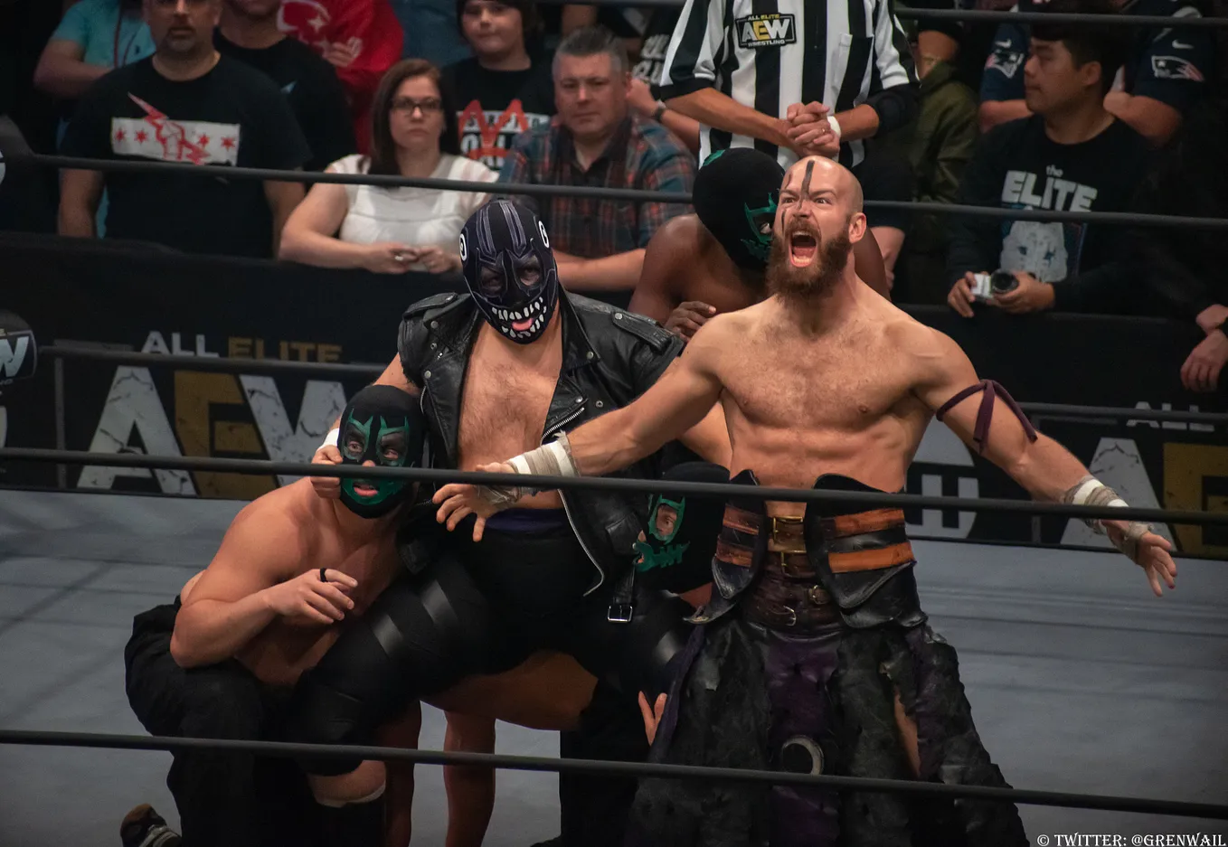 Evil Uno and Stu Grayson celebrate in the ring during an AEW event in 2019.