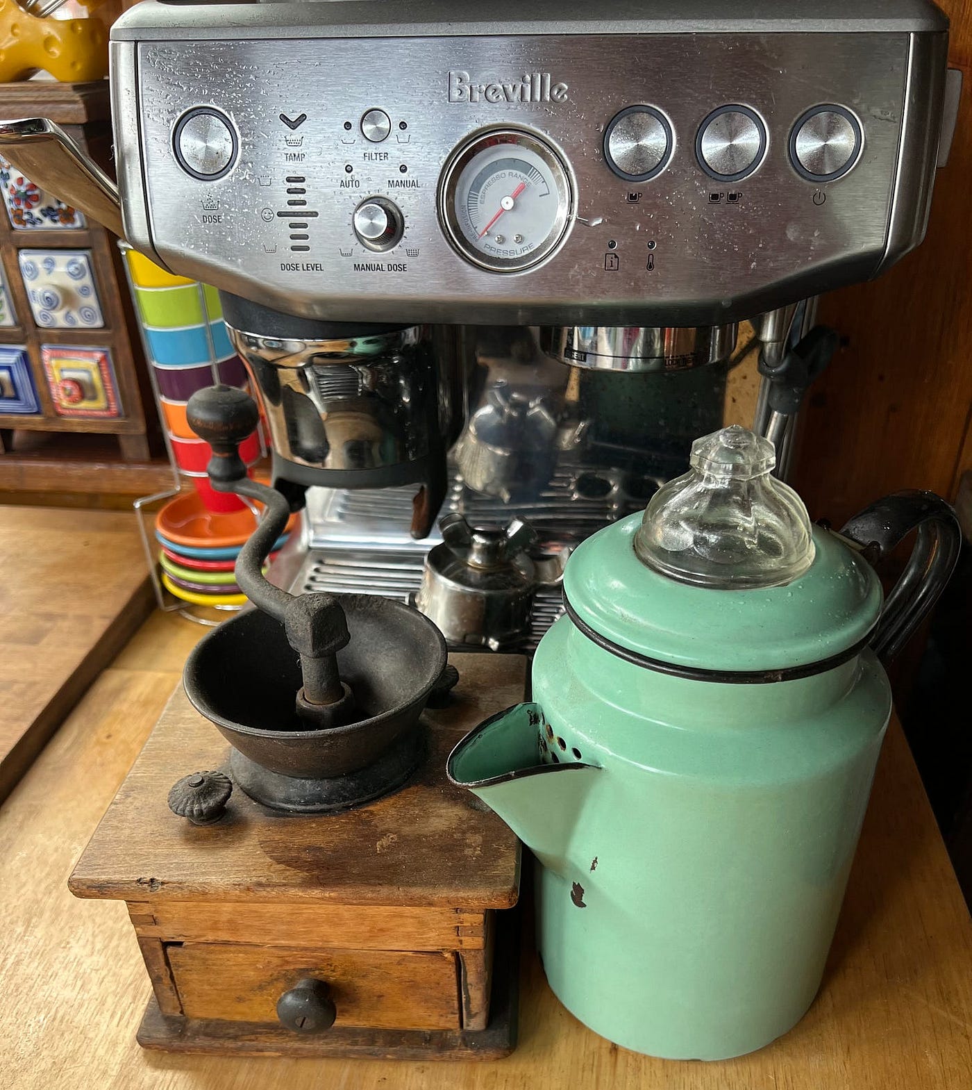 I display this old coffee grinder — my paternal grandparents had one just like it — and an old stovetop percolator in my kitchen. For this picture, I placed them in front of a modern espresso maker just for the contrast. If the apocalypse hits, these objects declare we will have coffee in this house one way or another. (Photo by Michelle Teheux)