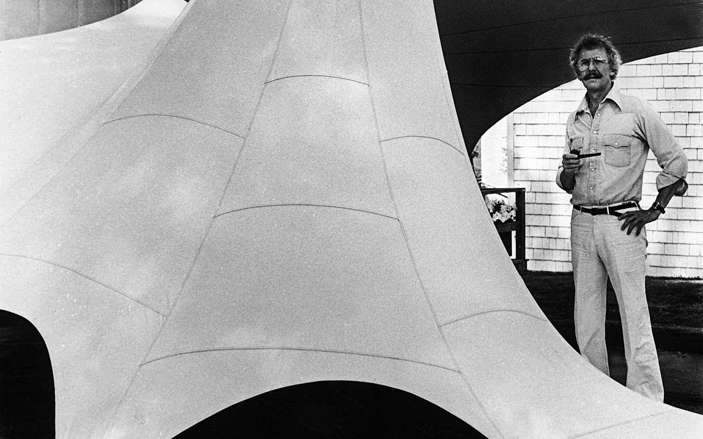 Bill Moss poses next to the fabric structure he created in 1970 for the Center for Maine Contemporary Art (CMCA).