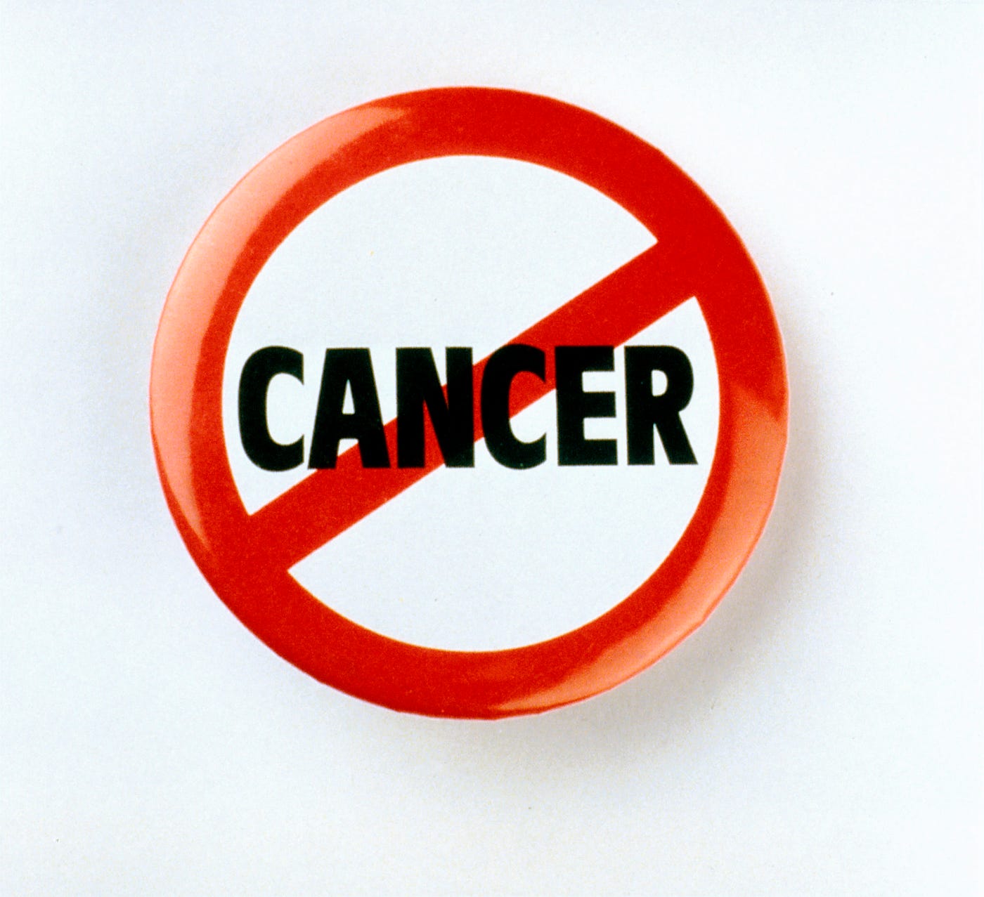 The word CANCER, with a red diagonal stripe crossing it. The American Cancer Society observes that scientists have reported T.H.C. and other cannabinoids (including CBD) slow growth or cause the death of certain types of cancer cells growing in lab dishes.