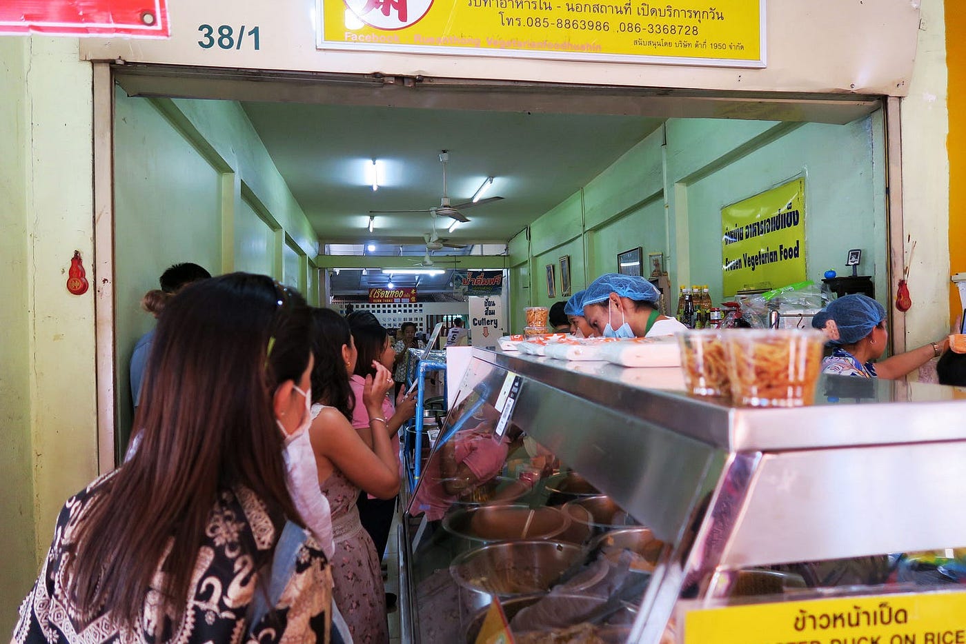 A long line of customers wait to order food at Ruen Tong Vegetarian restaurant.