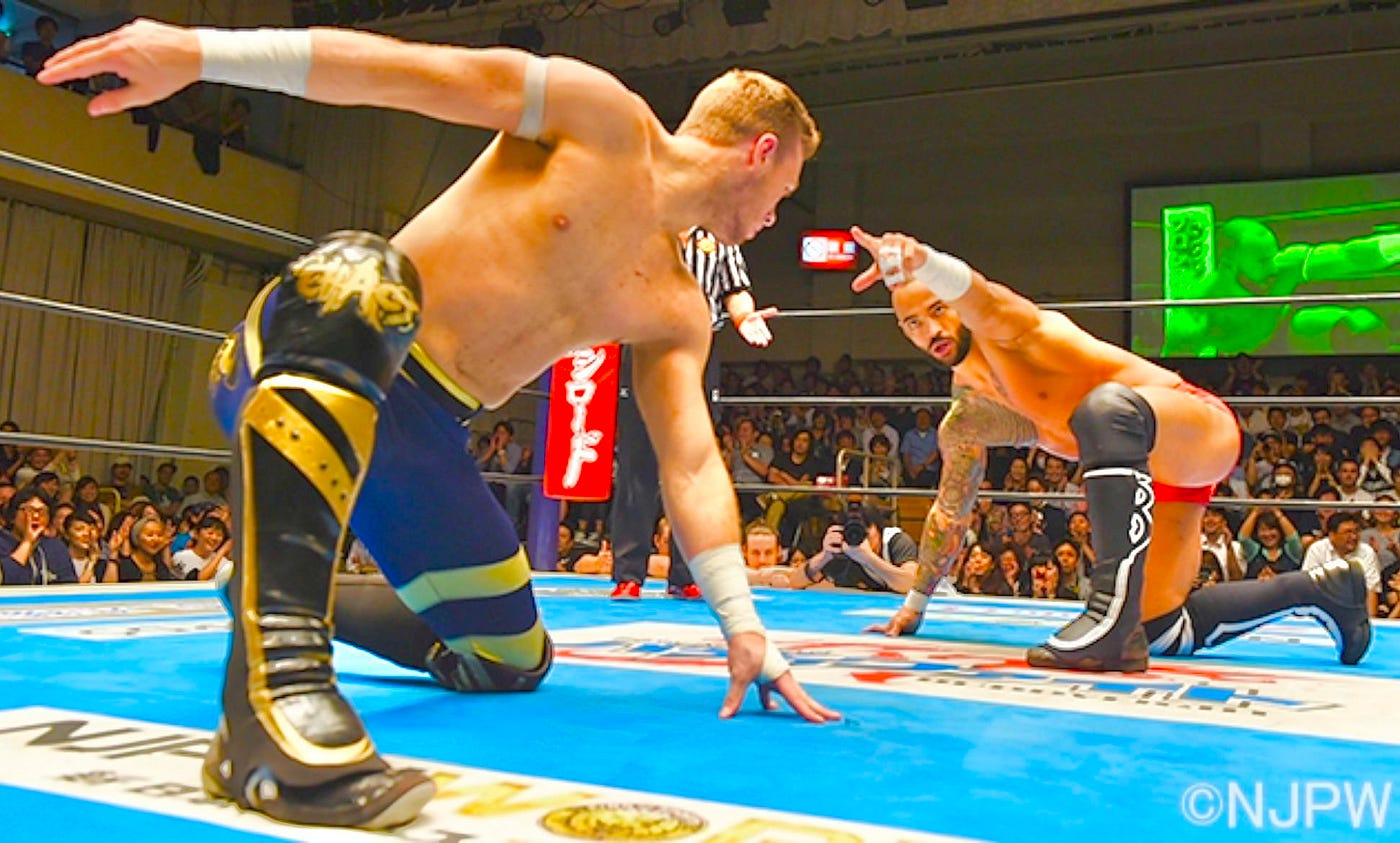 Ospreay & Ricochet staring down in dual superhero poses