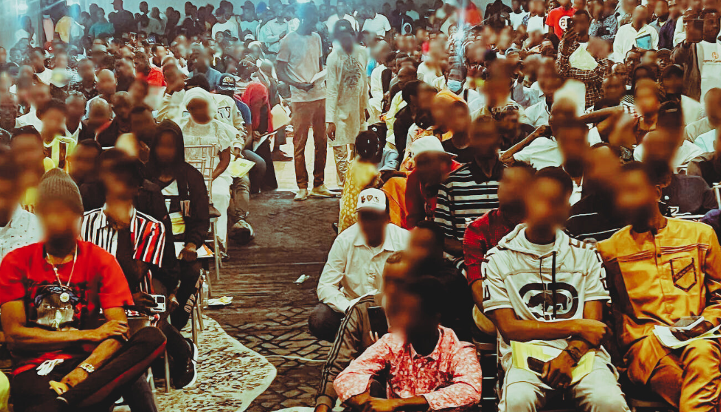 People sit in a hotel conference room and listen to lawyers talk about the U.S. asylum application process.