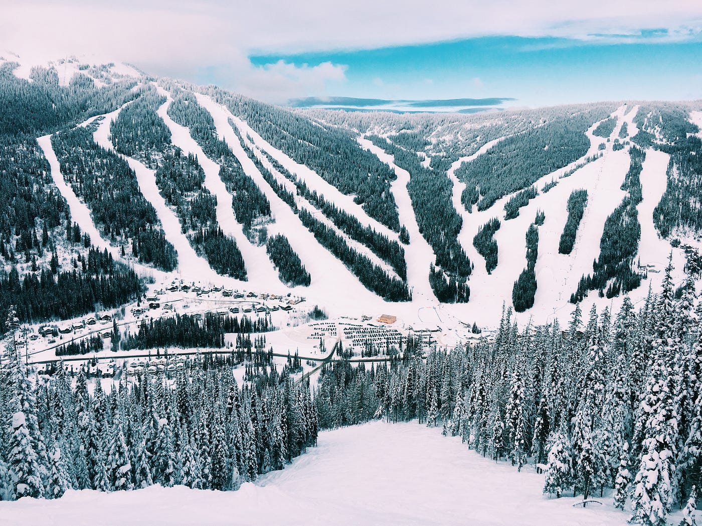 A photo of a mountain in the distance with all the many ski slopes visible.