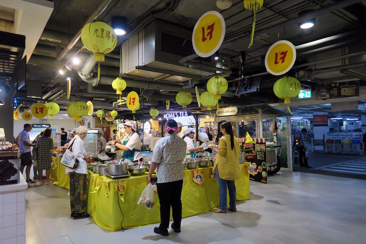 Customers buy food at the je section of the food court in Market Village.